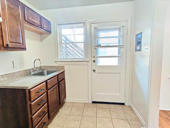 Kitchen has a private back entrance to the apartment
