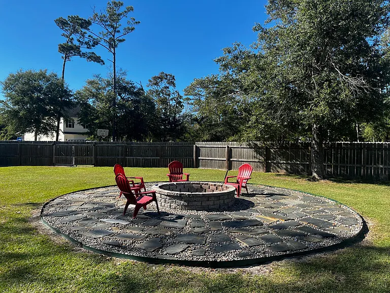 Oversized stone firepit and patio area perfect for relaxing or entertaining outdoors.