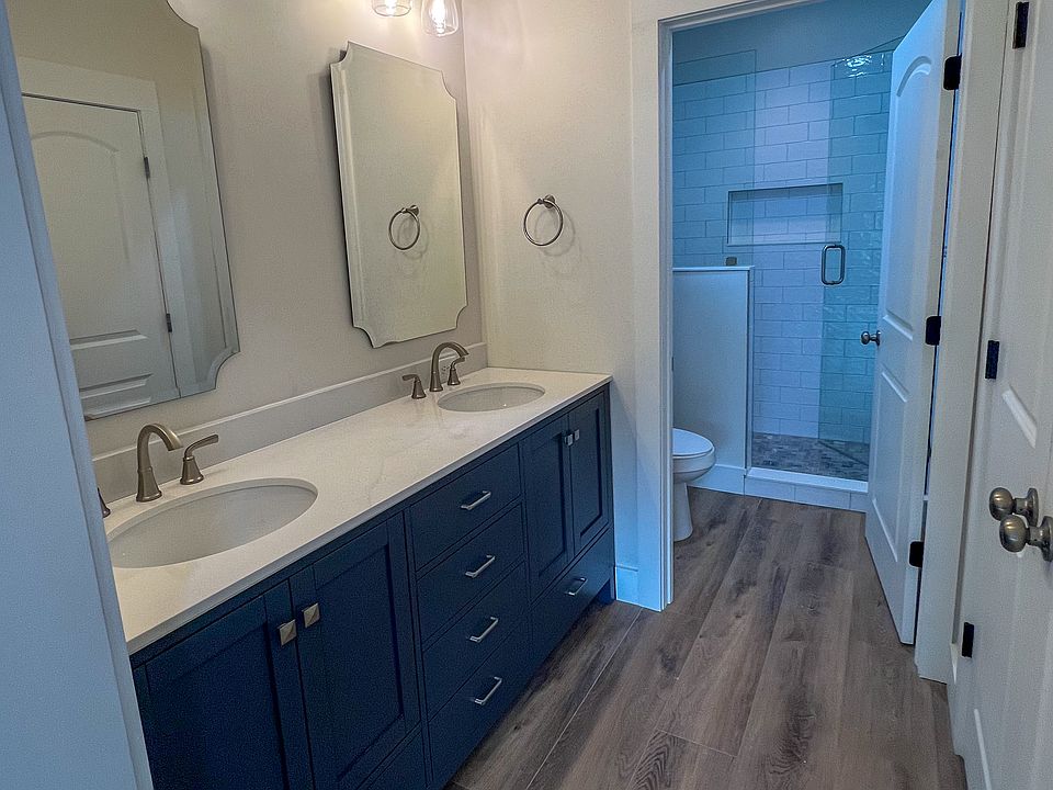 Primary Bathroom with double vanity, closet, and separate shower and bathroom