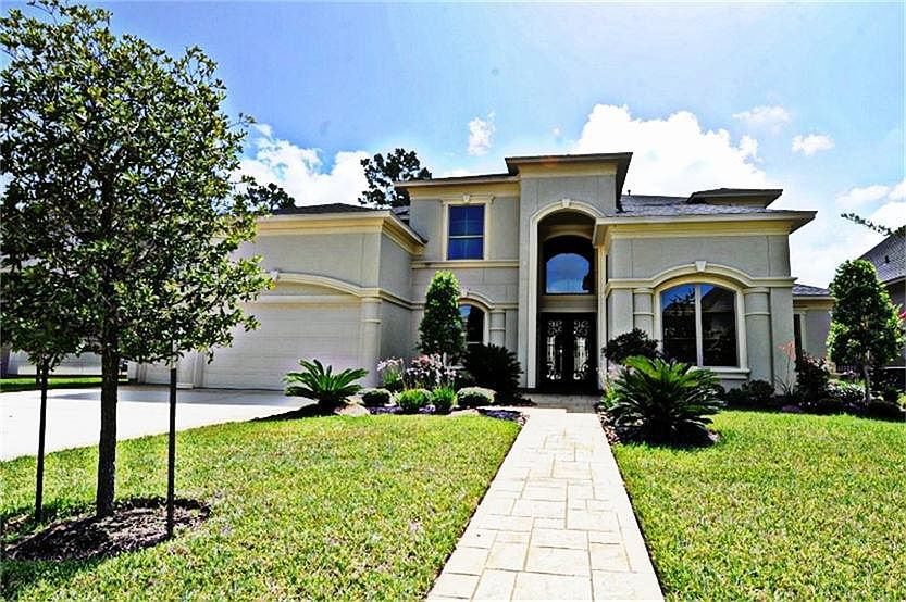 Stunning Stucco 5,200 SF Home With All The Bells And Whistles! This Home Includes A Sprinkler System