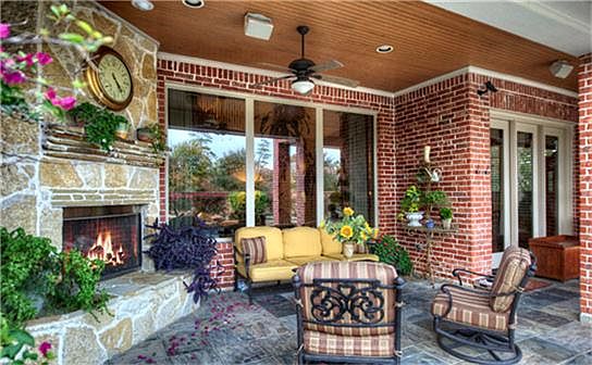 This outdoor custom stone fireplace begs for you to cozy up next to it with a glass of wine on a cri