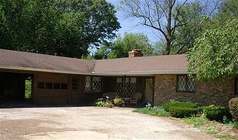 Large walk-out ranch on beautiful wooded 2.1 Acres of nature with 255' frontage on Hickory Creek !