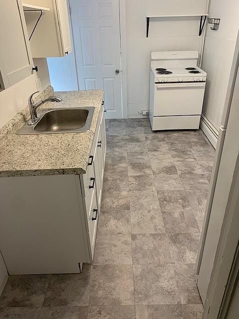 Spacious kitchen with dining nook. Convenient shelving and peg board storage. Three way ceiling light.