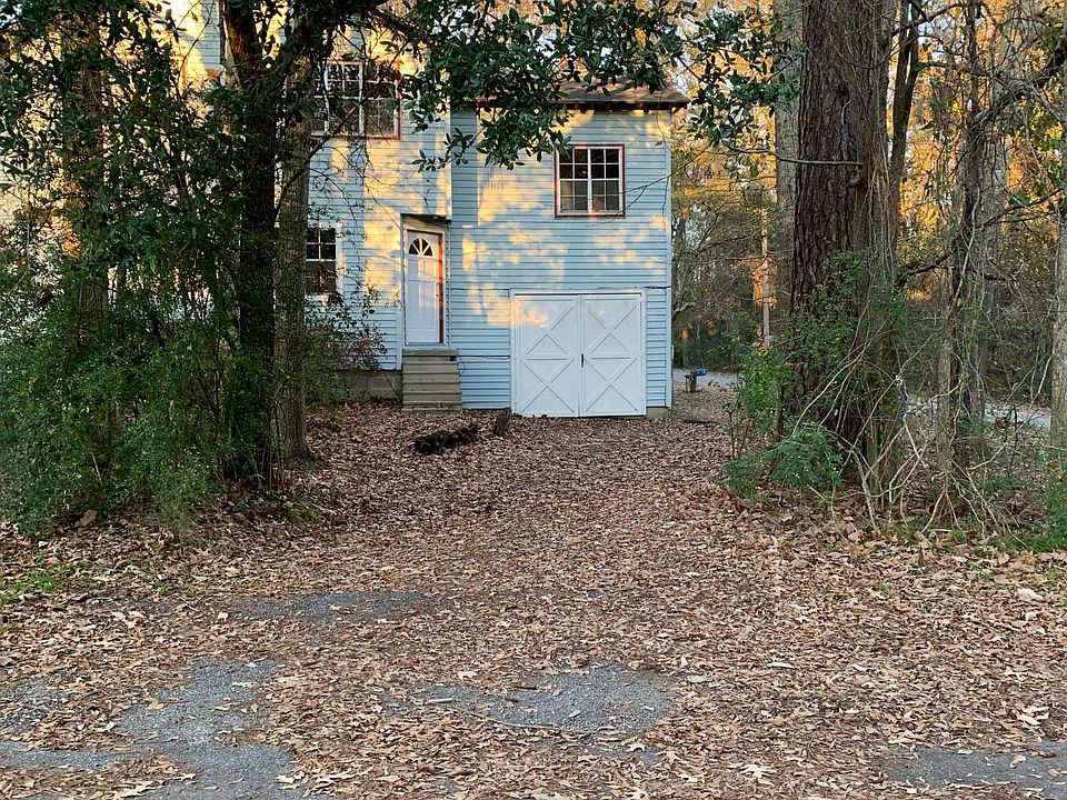 Front of home shaded by beautiful trees