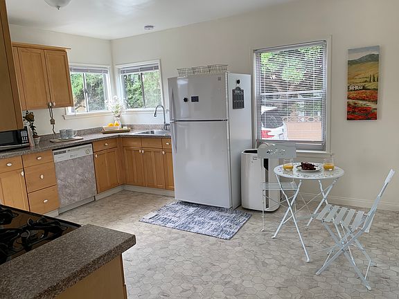 Kitchen equipped with washer, dryer, stove, dishwasher, and refrigerator