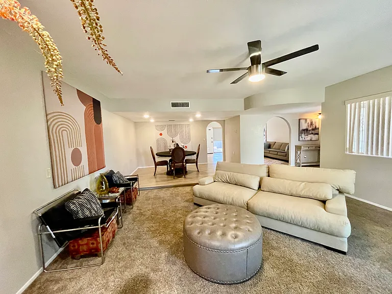 living room and dining room looking into archway to family room & kitchen