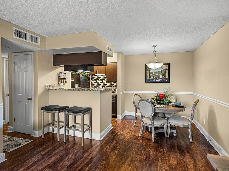 Open dining space with breakfast bar seating and easy access to the kitchen.