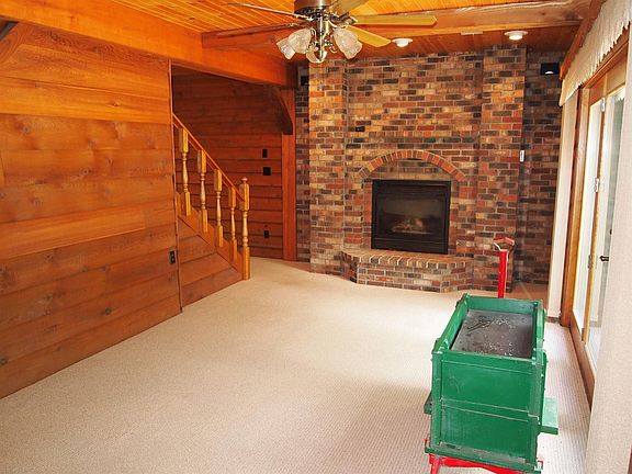 Gorgeous knotty pine family room with brick gas fireplace