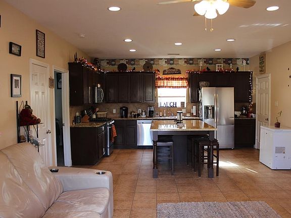Open concept. Tile floor. Ceiling fan in the living room.