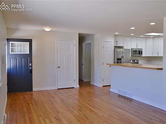 Easy Main Level Living with Beaming Original Oak Hardwood Floors in Great Room a