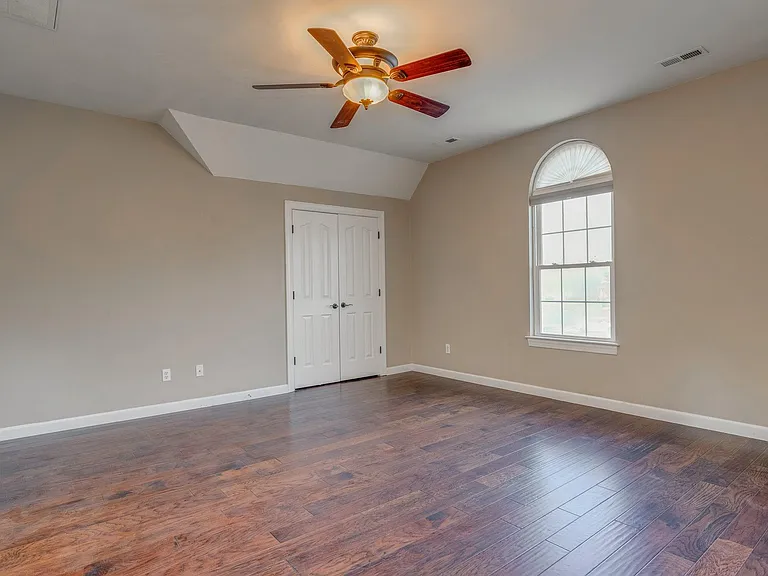 5th Bedroom / Room over garage, flexible space with hickory wood floors.