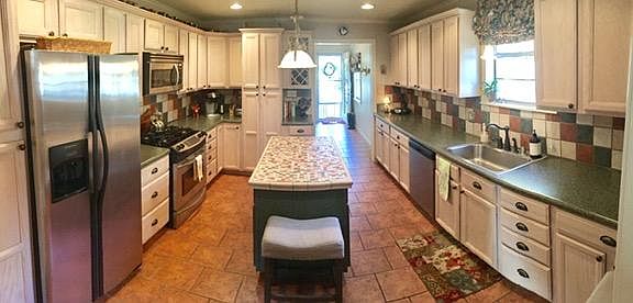 Large kitchen with SS appliances and abundant storage.