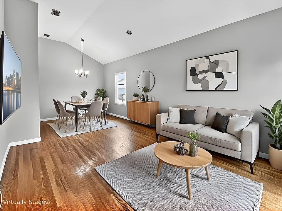 spacious living and dining areas with vaulted high ceilings
