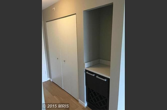 Front entrance with closet, bar, and wine rack
