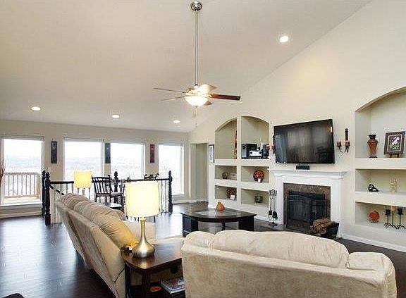 Great room with vault, window wall & custom display shelves