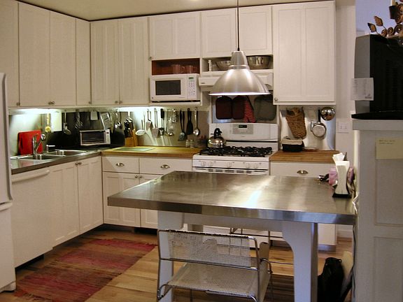 Kitchen w/ attached laundry room, pantry and mudroom. Opens to screened porch