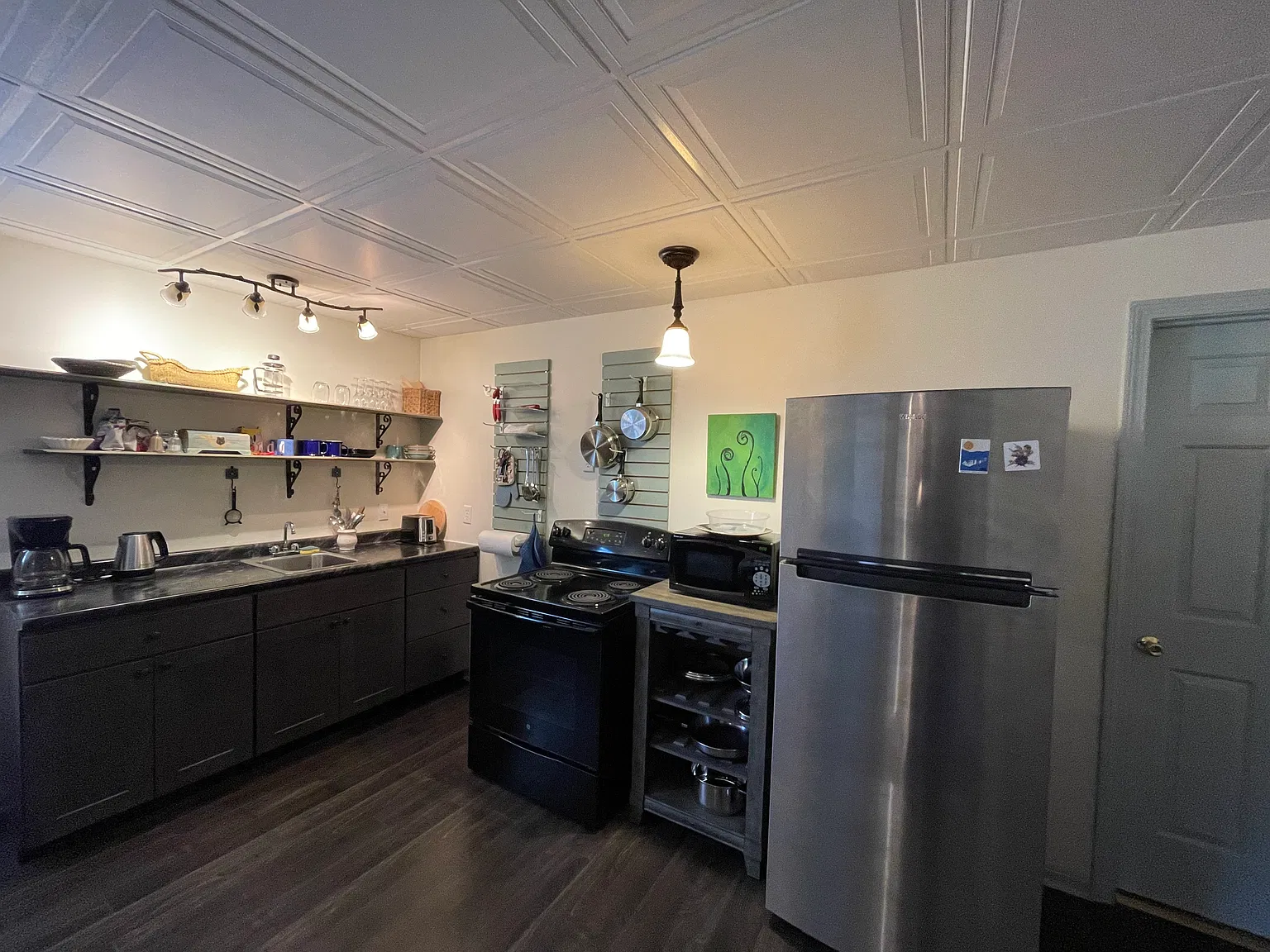 Kitchen area, Stove,fridge,microwave,coffee pot, hot water kettle, utensils, cups,plates glasses, pots and pans.