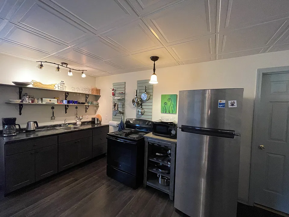 Kitchen area, Stove,fridge,microwave,coffee pot, hot water kettle, utensils, cups,plates glasses, pots and pans.