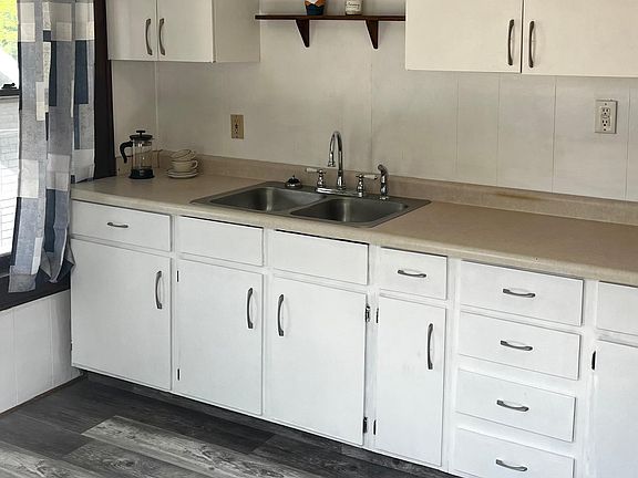 Freshly painted kitchen. New flooring August 2023. Deck off kitchen with private entrance.