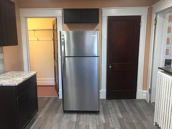 Basement door on left of fridge and one of the pantry/closet doors on right.