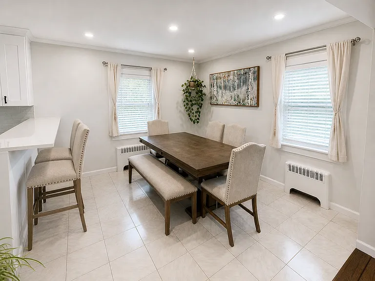 Dining area with sunny, dual exposure, breakfast bar, and plenty of room for larger gatherings around the table!
