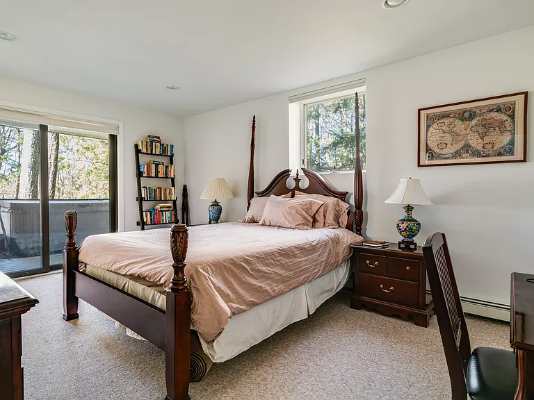 4th bedroom, on the lower level, with queen bed. entrance to the lower deck and the hot tub.