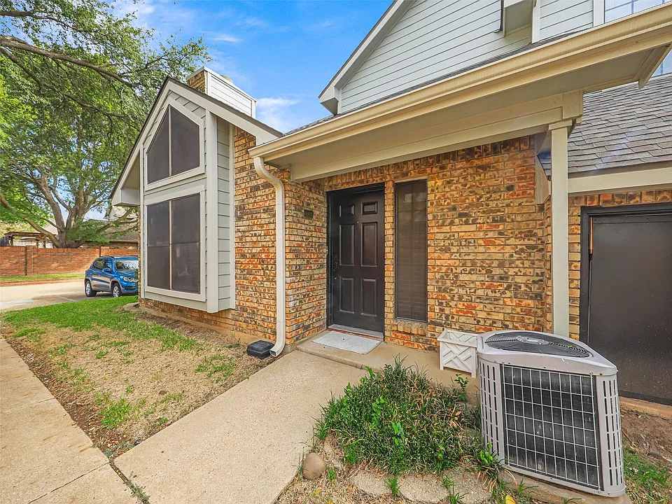 Multi-textured exterior featuring a brick facade, siding accents, a prominent gable roofline, and a panelled front door