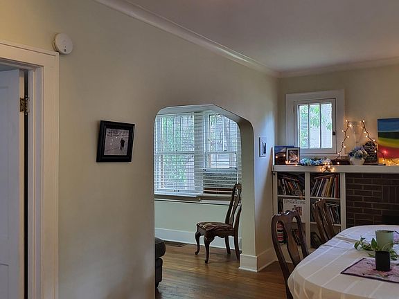 Living room (with dining table in it) looking into dining room.