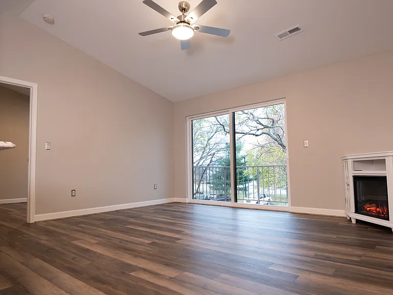 Living room and kitchen with sliding glass doors to the deck.