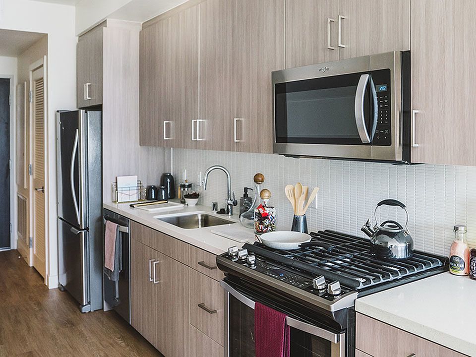 Gally Kitchens with gorgeous cabinetry, tile backsplash and quartz countertops.