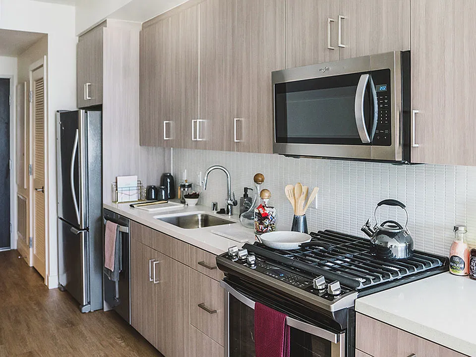 Gally Kitchens with gorgeous cabinetry, tile backsplash and quartz countertops.