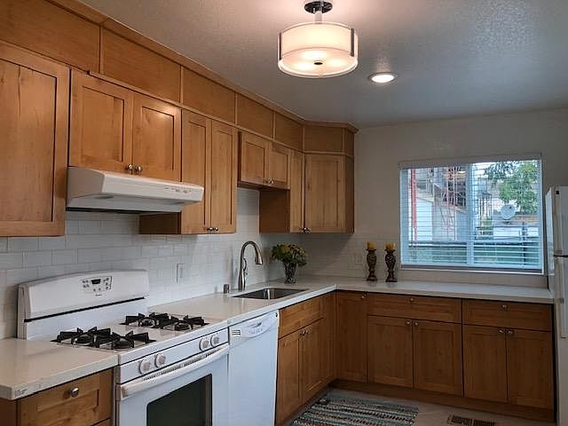 Beautiful eat-in kitchen with two large windows for ample natural light. Maple shaker cabinets, white subway time backsplash, quartz counter top, gas stove, dishwasher and refrigerator, tile floors, LED lighting.