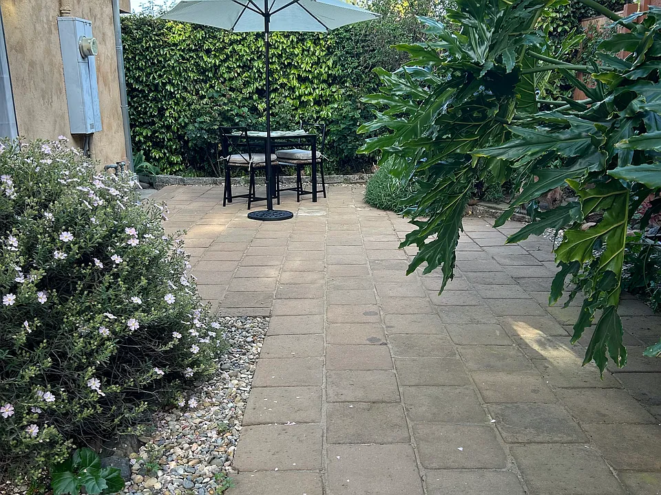 Patio with umbrella and table/chairs.