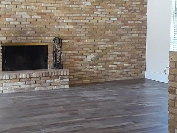 Living room with vaulted ceiling and fireplace