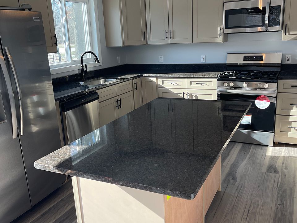 Spacious kitchen with granite countertops and eat in island.
