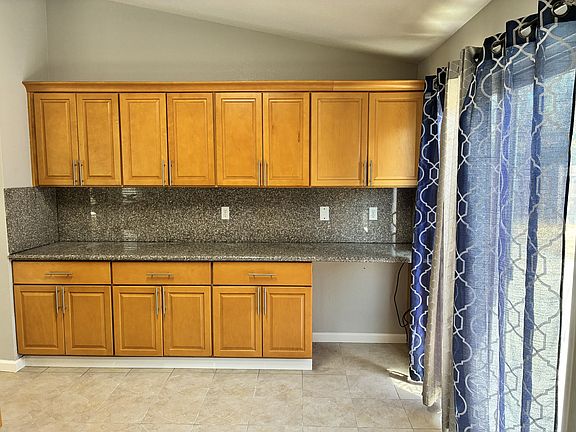 Kitchen, other wall with cabinets and countertop + built-in workdesk.