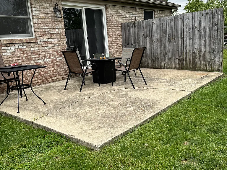 Back patio with propane fire pit and seating for six.