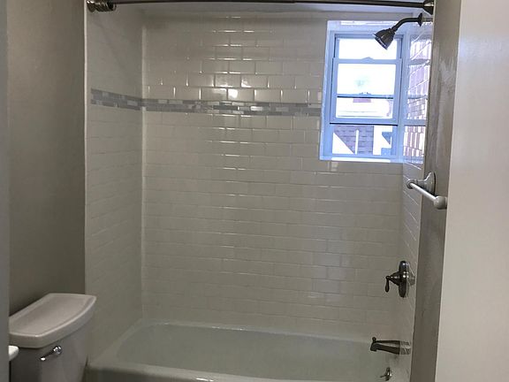 new bathroom with subway tile and tub/shower combo