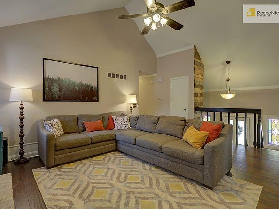 Main living area with vaulted ceiling and fireplace.