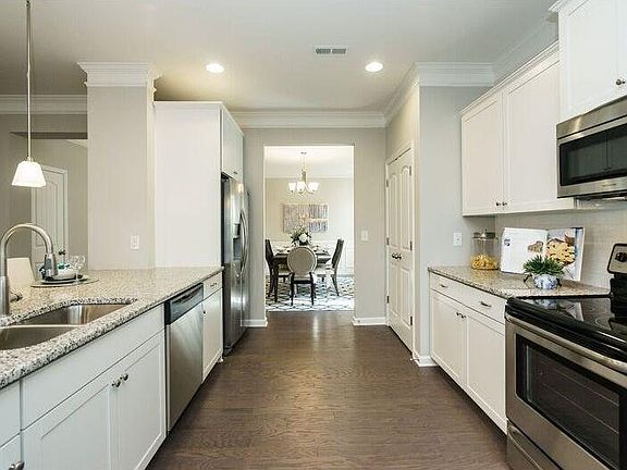 The kitchen offer granite countertops, large island with breakfast bar, gas or electric ranges avail