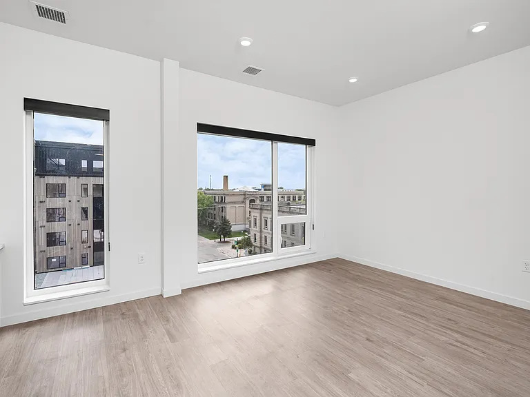 Bright and airy room with modern finishes and large windows offering city views. Bright and airy room with modern finishes and large windows offering city views.