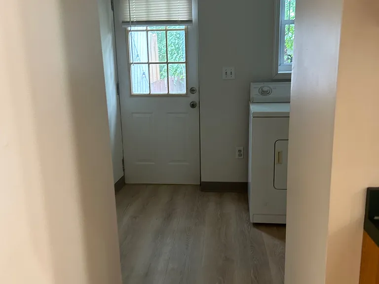 view from kitchen to laundry room and back door to patio