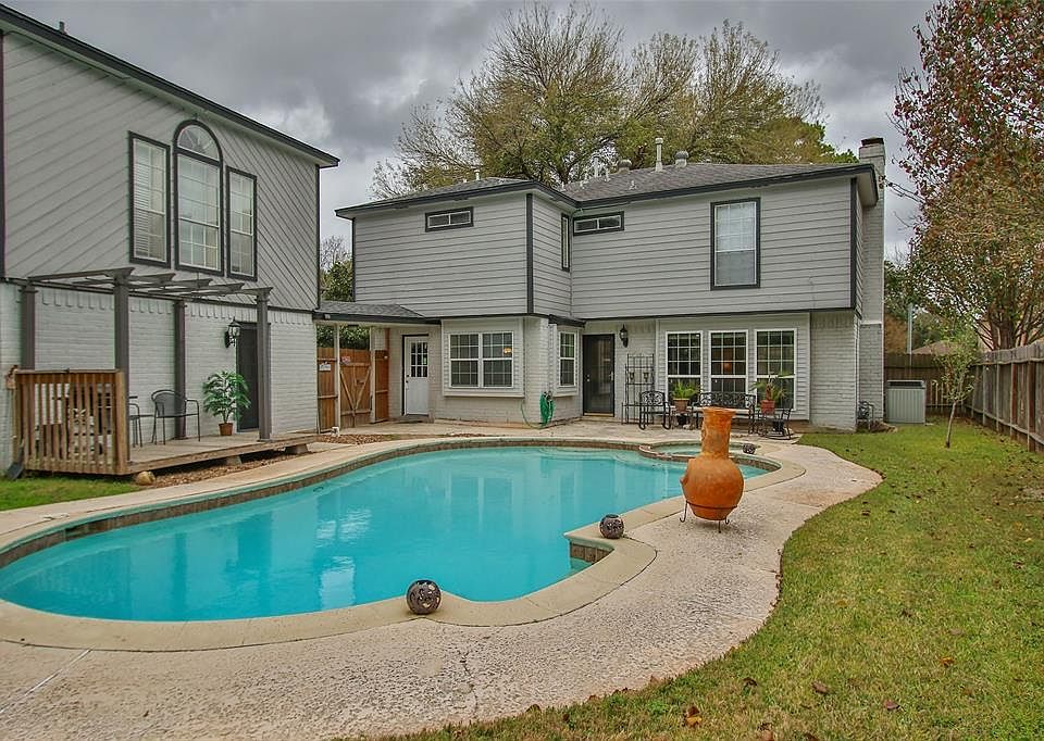 Sparkling pool can be seen from the wall of windows in the home's living room as well as from the guest apartment over the garag