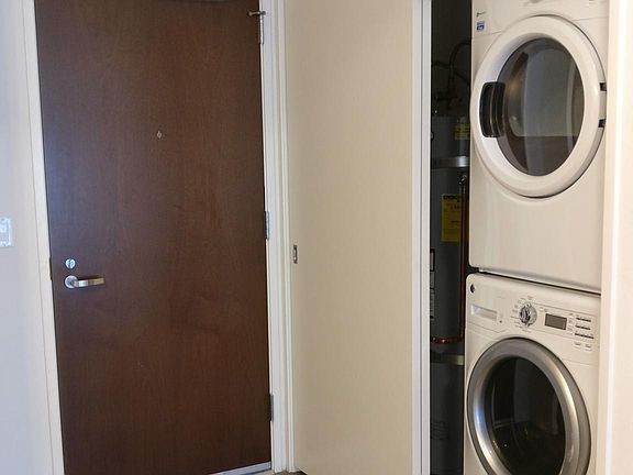 Main entrance to the unit. Washer/dryer are visible, with water heater next to them.