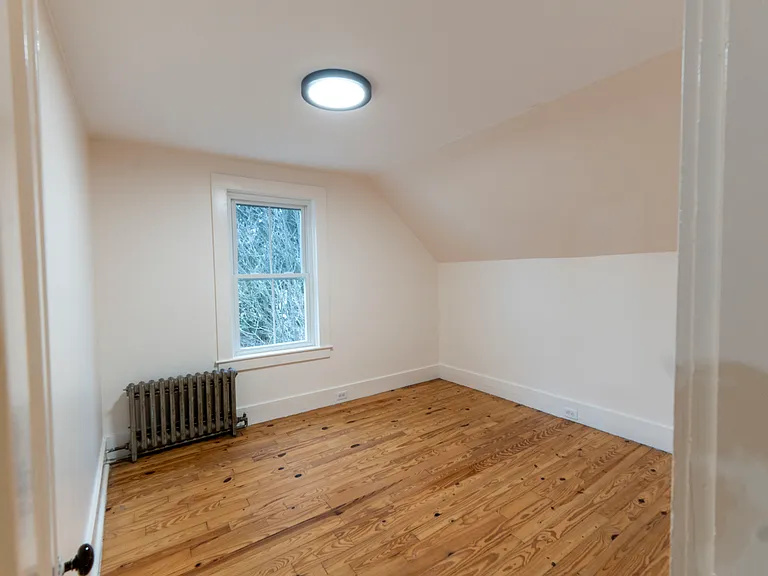 Smaller bedroom looks out across backyard. it can fit a queen size bed or two twin beds.