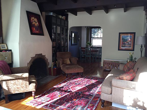 Livingroom with wood-burning fireplace and bookshelves.