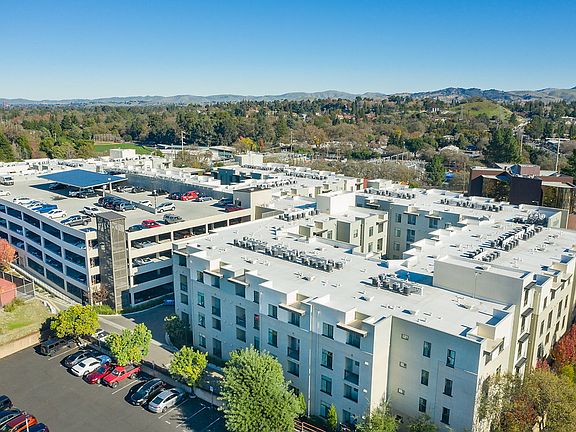 Aerial view of building exterior and views.