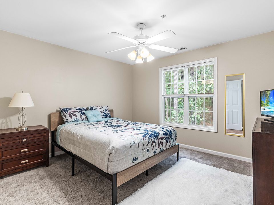 Master bedroom with queen bed and TV