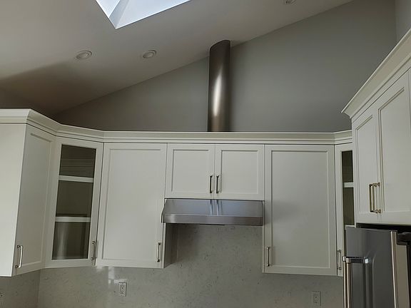 Kitchen with high ceiling and skylights