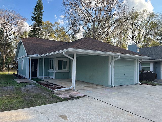 Front of the house with your garage and car port.